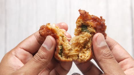 fried indonesian meatballs in hands