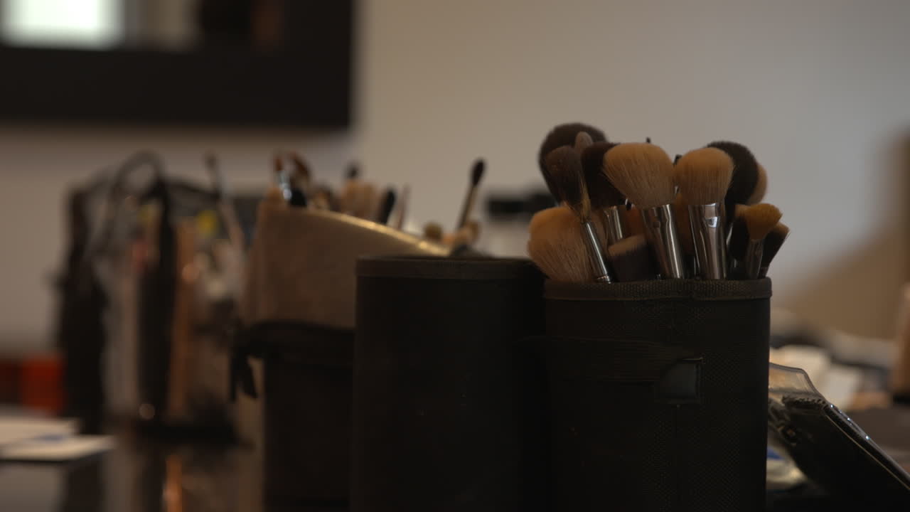 Slow pan over a make up artists table with their utensils
