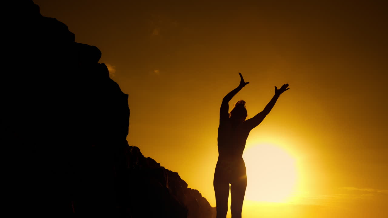 mujer disfrutando de la puesta de sol en la playa