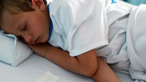 patient resting with teddy bear on bed