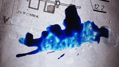 blue ink dripping onto a transparent blueprint of an apartment