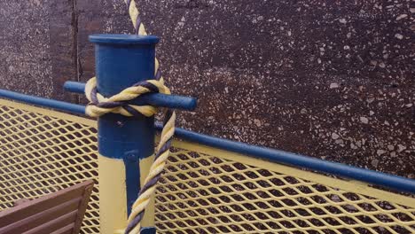 mooring rope and bollard on sea water tenses up, close up