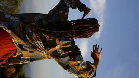 Stylish-woman-dancing-in-countryside