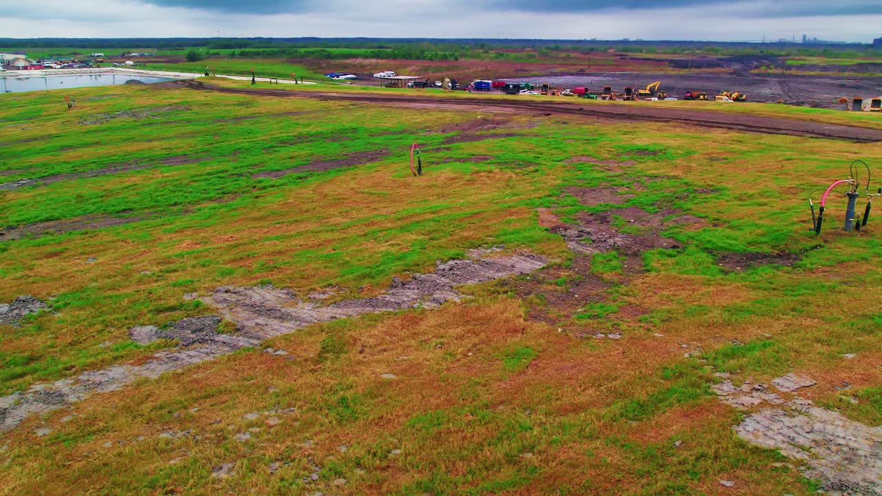 Orbit shot of Louisiana landfill with gas wells
