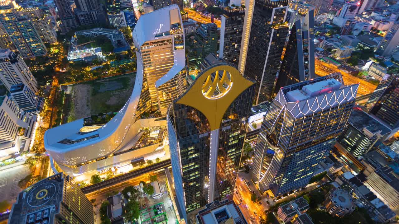 Aerial view of Ploenchit junction with cars traffic skyscraper buildings. Bangkok City in downtown at night, Thailand