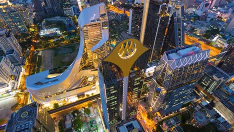 aerial view of ploenchit junction with cars traffic skyscraper buildings. bangkok city in downtown at night, thailand