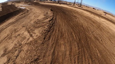 dirt biking on a damp muddy road in california - go pro on helmet