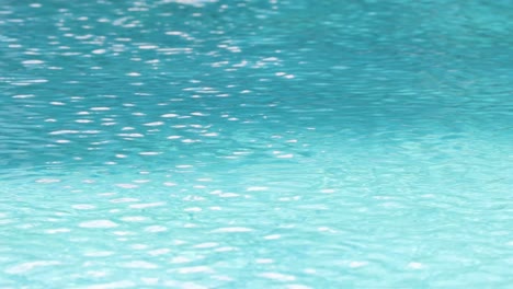 close-up view of shimmering aqua water with gentle ripples reflecting light.