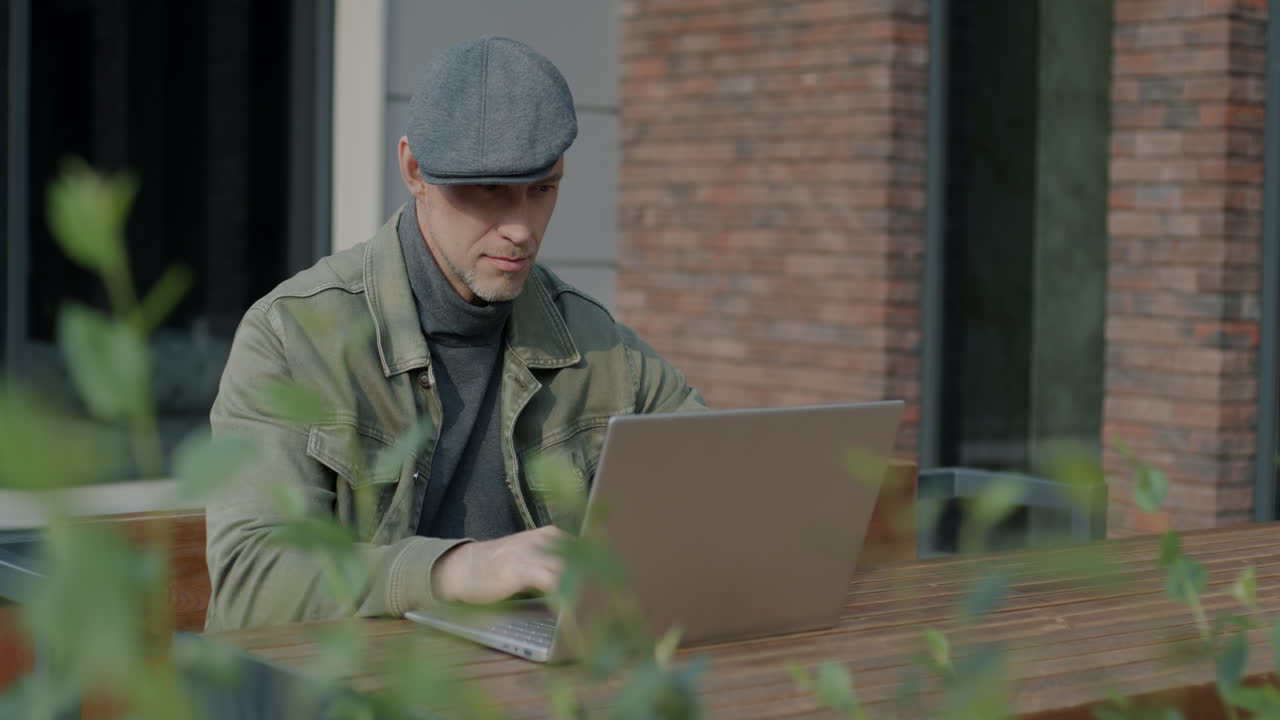 Man Working on Laptop Outdoors