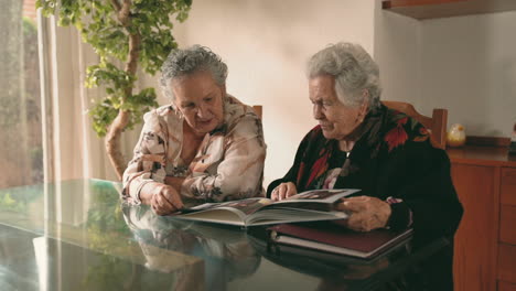 aged women examining photos together