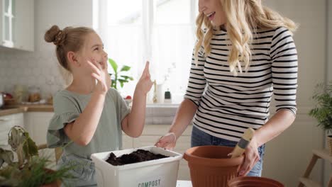 video of girl and woman doing compost.