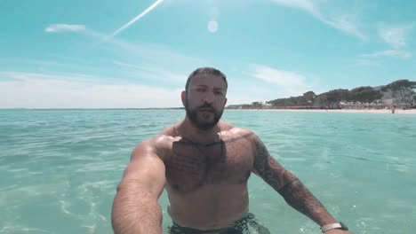 man filming himself in the sea