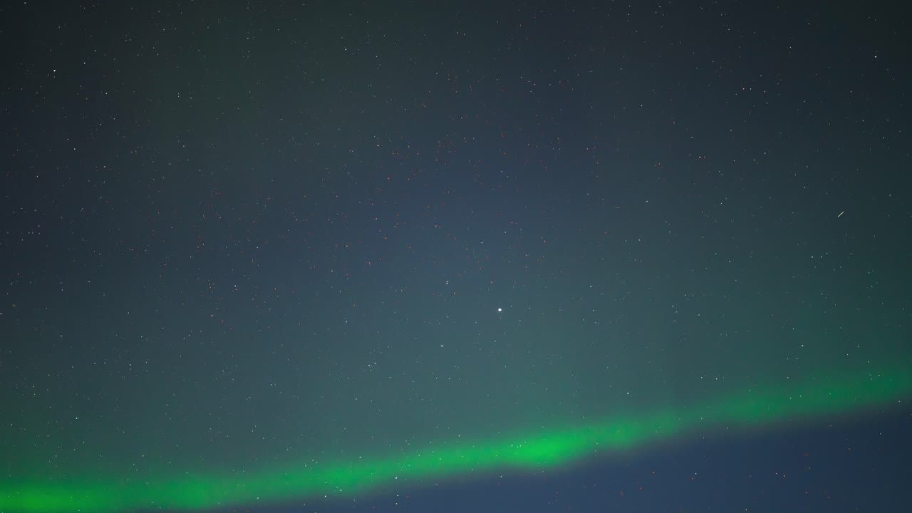 Northern lights glowing in the night sky, timelapse capturing their movement