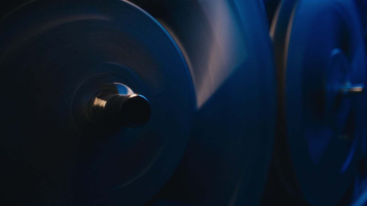 A vintage tape recorder spinning spools in a blue light