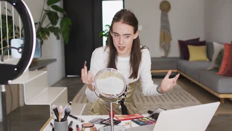 Caucasian non-binary transgender woman making make up video