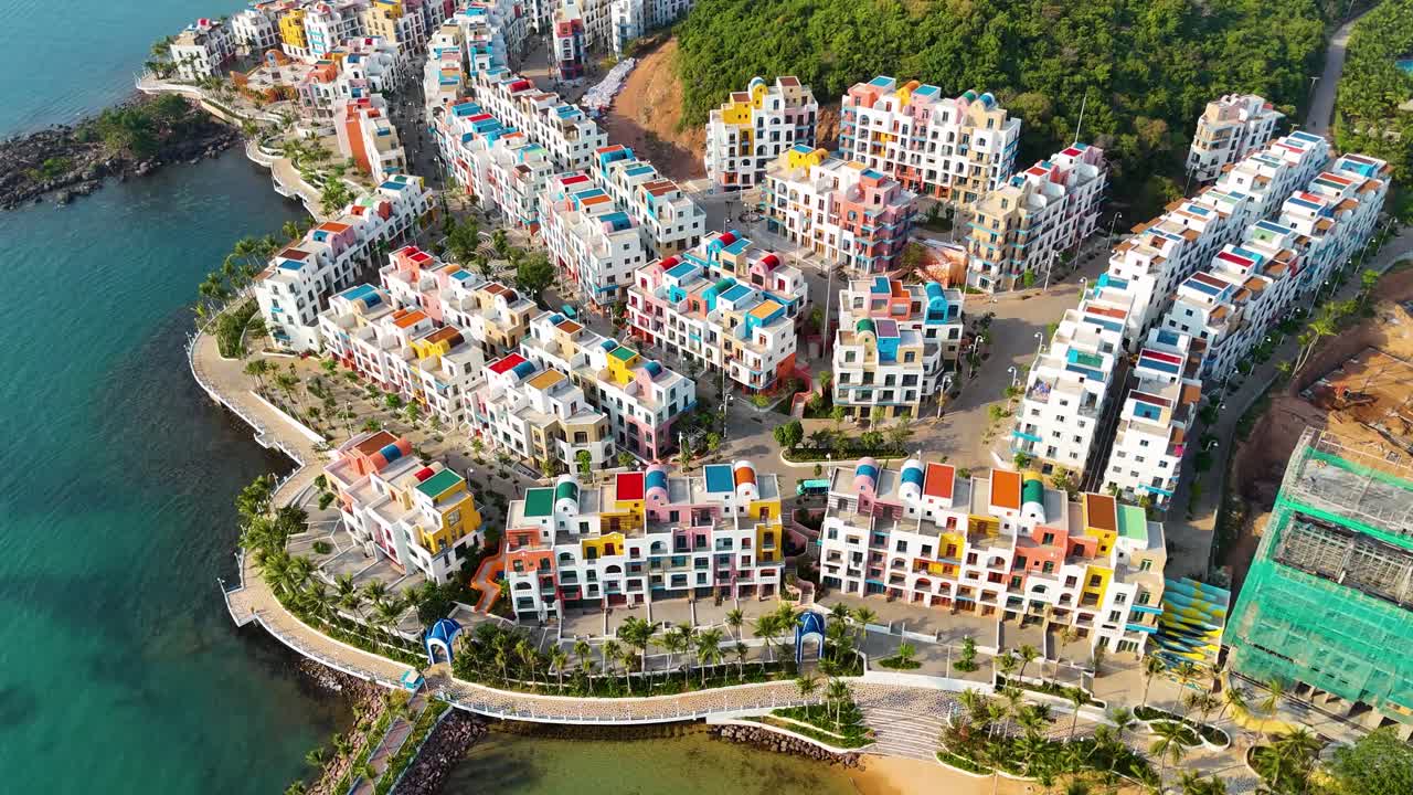 Aerial: Vinhomes fake Santorini construction site during the day in Sunset Town, Phu Quoc Island, Vietnam, orbit drone shot
