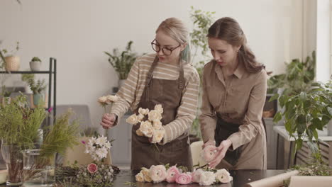 Woman Bringing Flowers to Colleagues in Shop