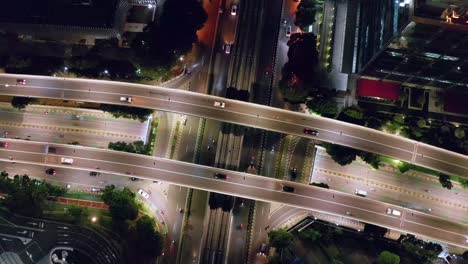 vehicles driving in the busy streets and highways at night in kuningan city, jakarta, indonesia