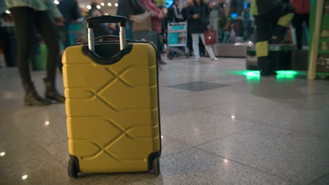 yellow trolley bag in airport or railway station