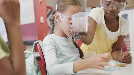 Happy-diverse-schoolgirls-doing-experiments-in-lab-in-slow-motion-at-elementary-school