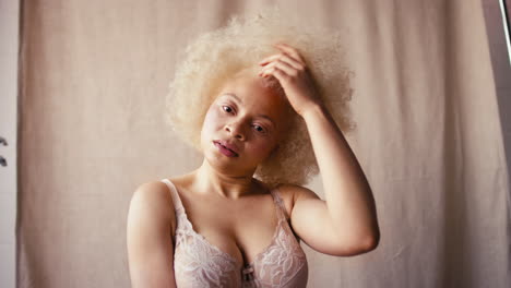 studio portrait shot of confident natural albino woman in underwear promoting body positivity