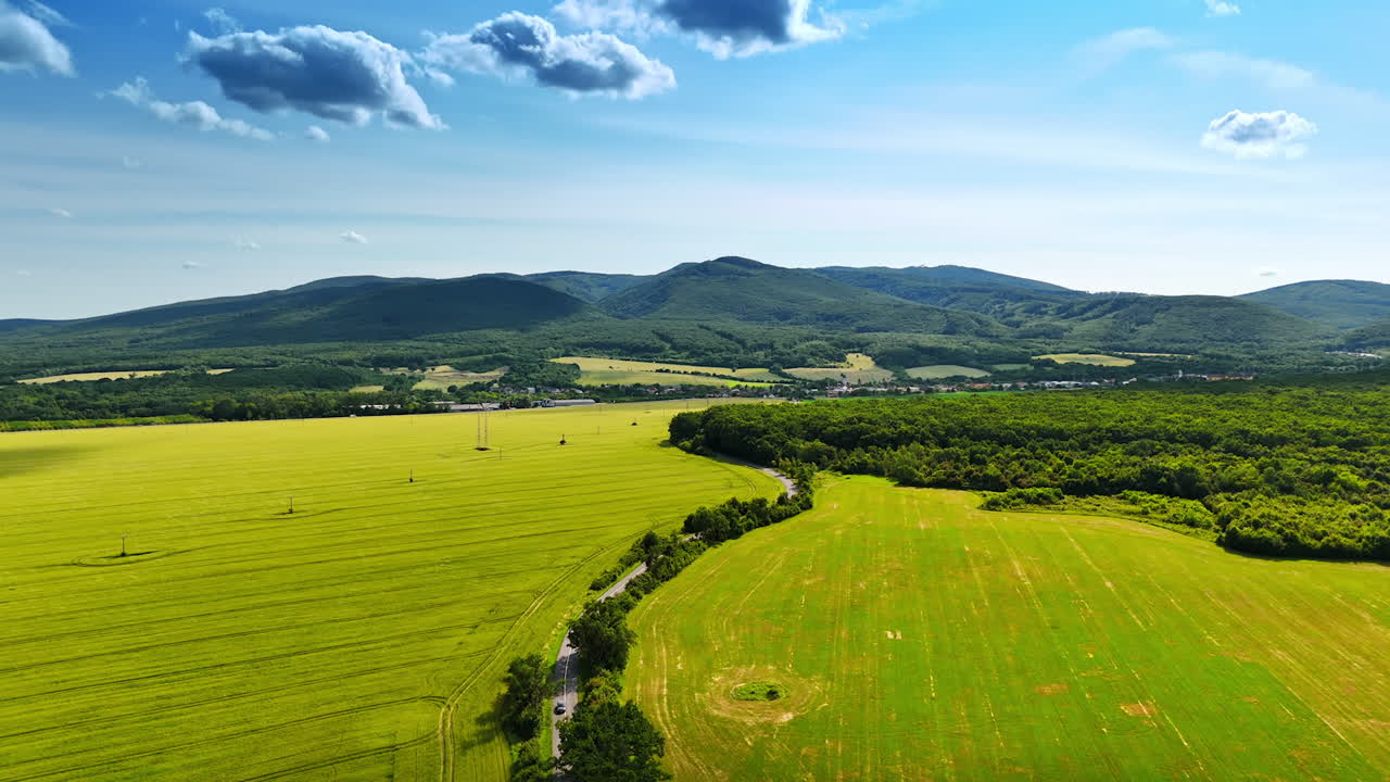 Vibrant European hills. Vast green fields and rolling hills under a bright blue sky evoke a sense of rural tranquility