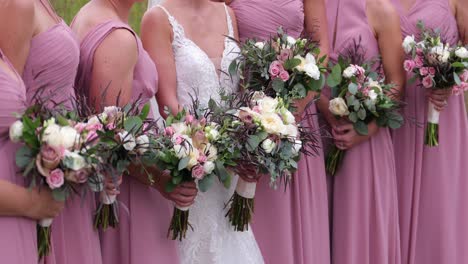 beautiful white, pink and green wedding bouquet with pink bridesmaid dresses