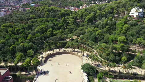 parc guell in barcelona, seen from above over the tree tops, summer