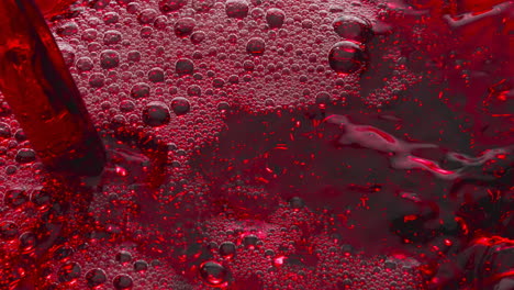 bubbled red wine pouring glass slow motion. alcoholic liquor filling wineglass