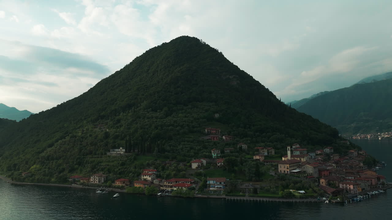 Scenic Village at the Base of a Large Mountain by a Lake