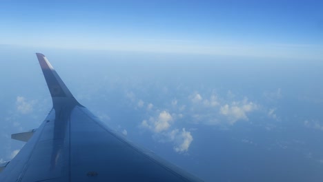 sky glider: a journey beyond the clouds – video shot showcasing serene skies, graceful wing motion, and soft cloud layers as the airplane glides through tranquil blue altitudes above the earth