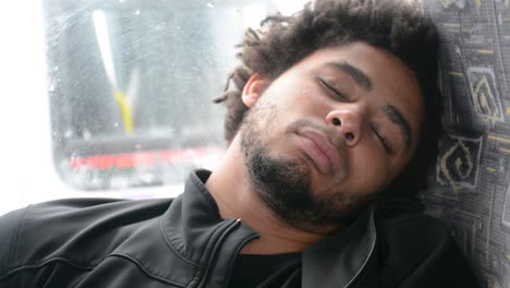 young african american black man sleeps on bus chair extream close up