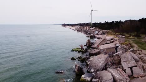 aerial view of abandoned seaside fortification building at karosta northern forts on the beach of baltic sea in liepaja in overcast spring day, wide drone shot moving forward fast