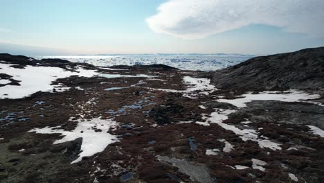 drone reveal icefjord in greenland full of melting icebergs during sunny day