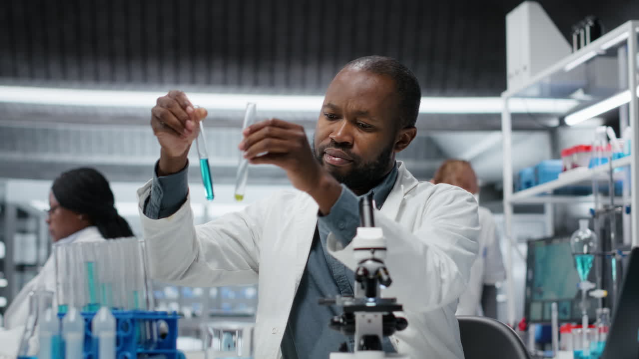 Molecular biologist in lab analyzing batch of blood samples