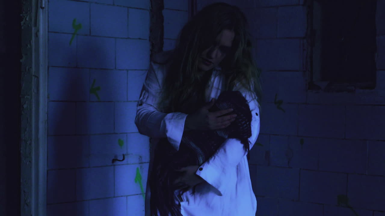 The ghost of a woman holding her newborn child in an old abandoned and haunted hospital