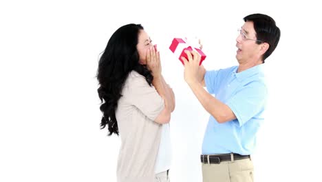 asian woman giving a gift to her husband