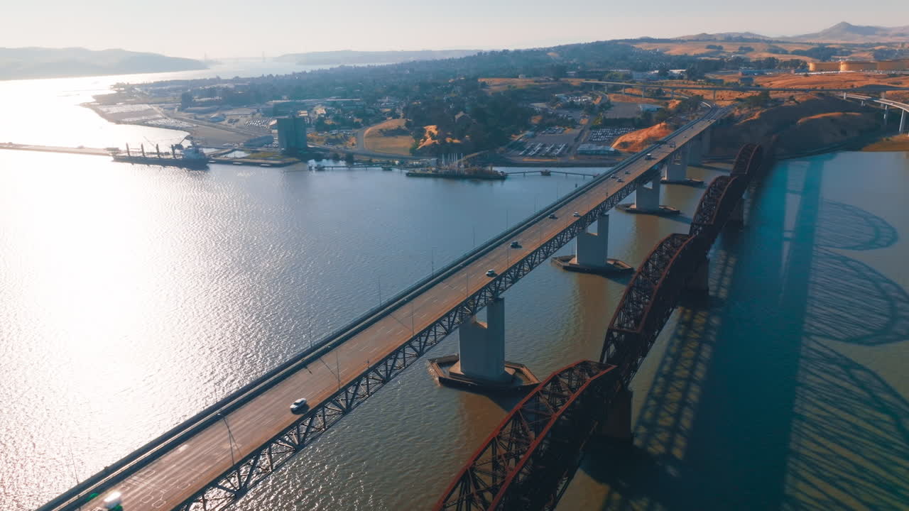 Flying over the bridges leading to Martinez, California, USA. Beautiful American city scenery at sunny daytime. Aerial view.