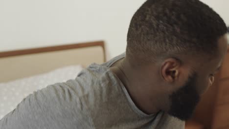 black man with headache in the morning. young male person rubbing temple.