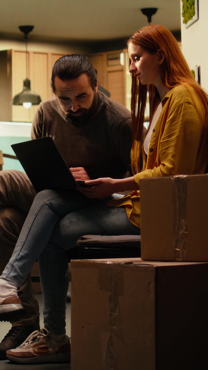 Vertical Video Young couple talking about furniture placement and interior design layout