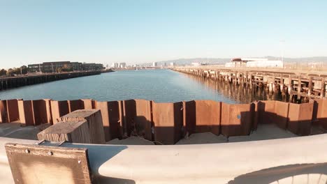 a rusty wall retains the bay in a large ship berth designed for huge cargo ships.