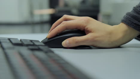 office worker using computer wired mouse while working