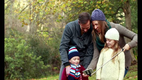 family taking selfie in countryside on autumn day