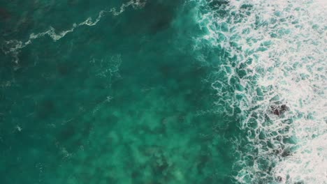 aerial shot of turquoise ocean waves crashing coastline of nusa penida island, one of the tourist attractions of bali island crystal beach kelingking beach angle billabong broken beach