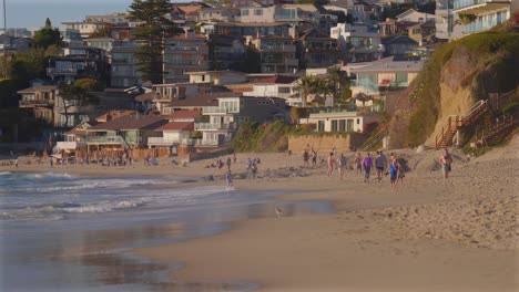 people walking along the beach in southern california