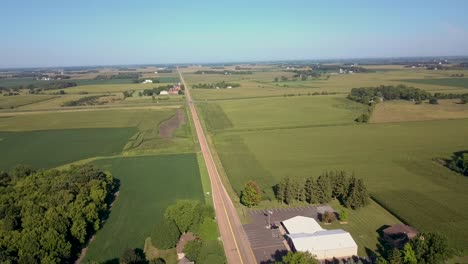 flying over grain bins on farm during summer