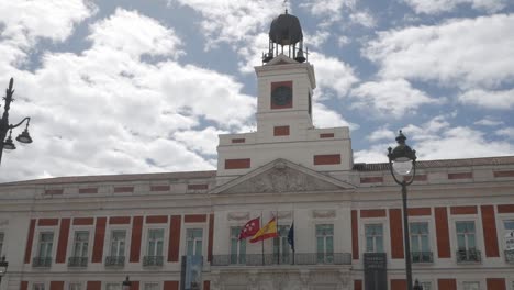 puerta del sol, iconic square in madrid, showing its historic clock tower and vibrant flags
