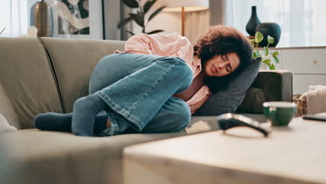 woman suffering from pain on couch