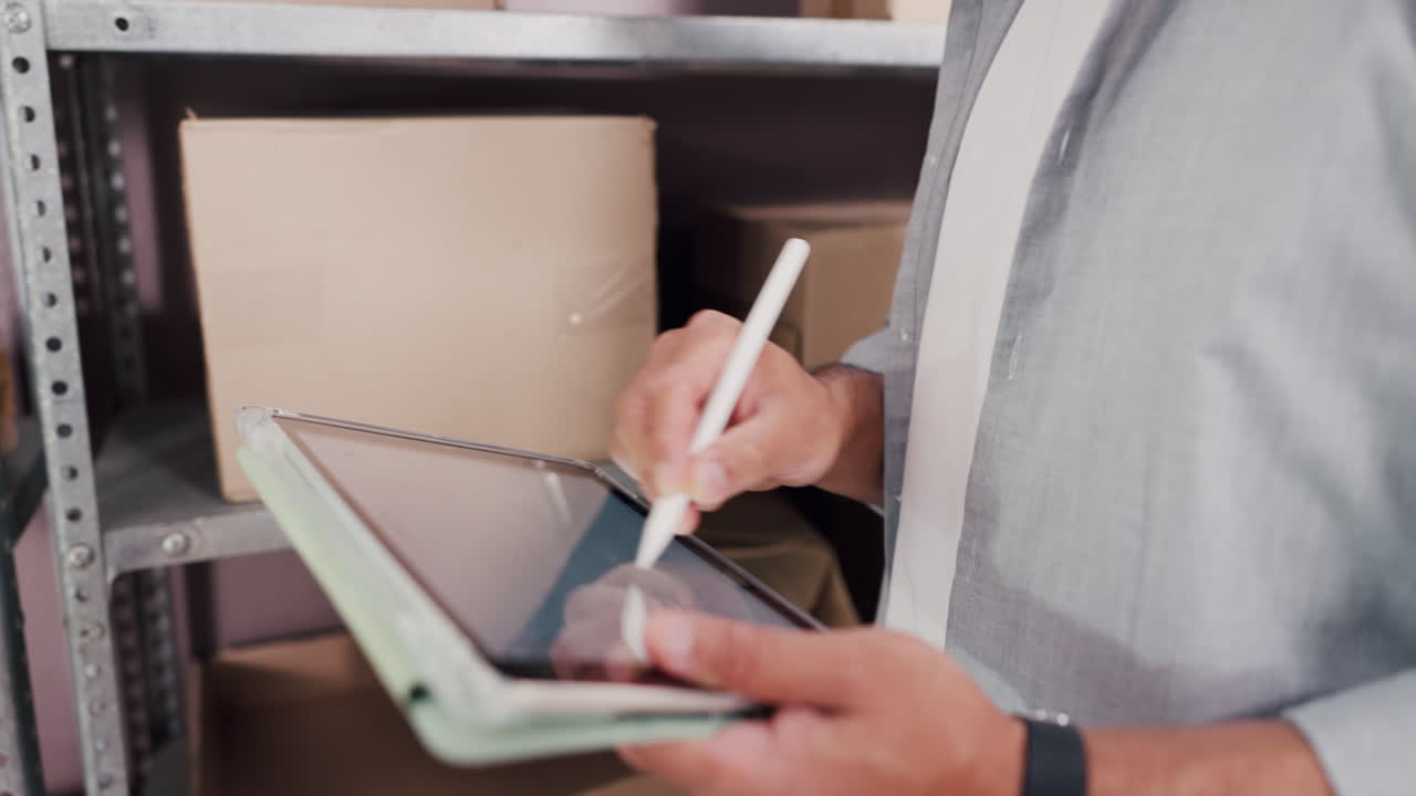 Man Using Digital Tablet with Stylus to Manage Warehouse Inventory