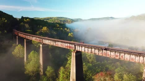 beautiful aerial over a steel railway trestle in the fog in west virginia appalachian mountains 1